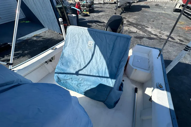 Slide: The Image of 2004 Palm Beach 161 Whitecap boat with blue cover in harbor. - 6