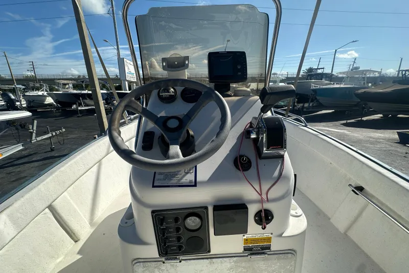 Slide: The Image of 2004 Palm Beach 161 Whitecap boat dashboard with steering wheel and controls. - 8