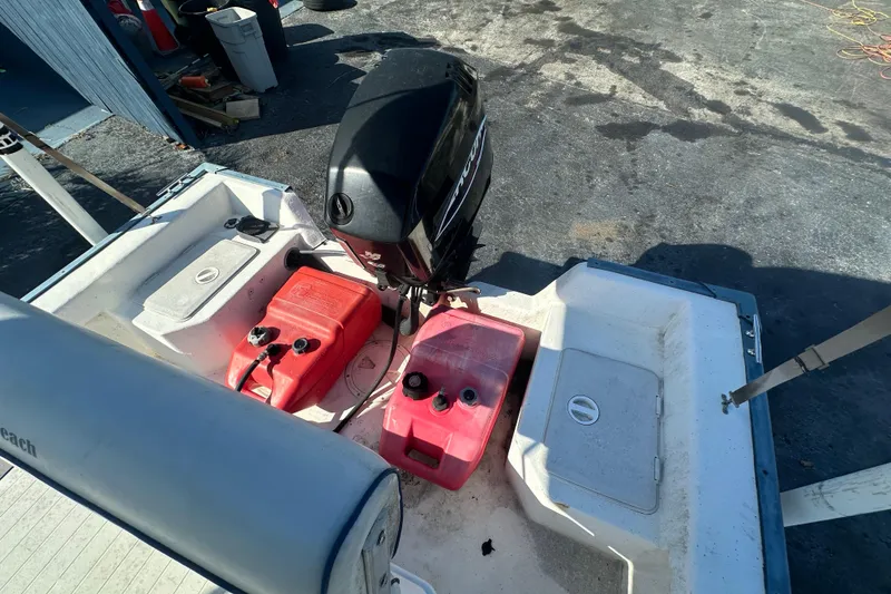 Slide: The Image of 2004 Palm Beach 161 Whitecap boat with outboard motor and fuel tanks on deck. - 9