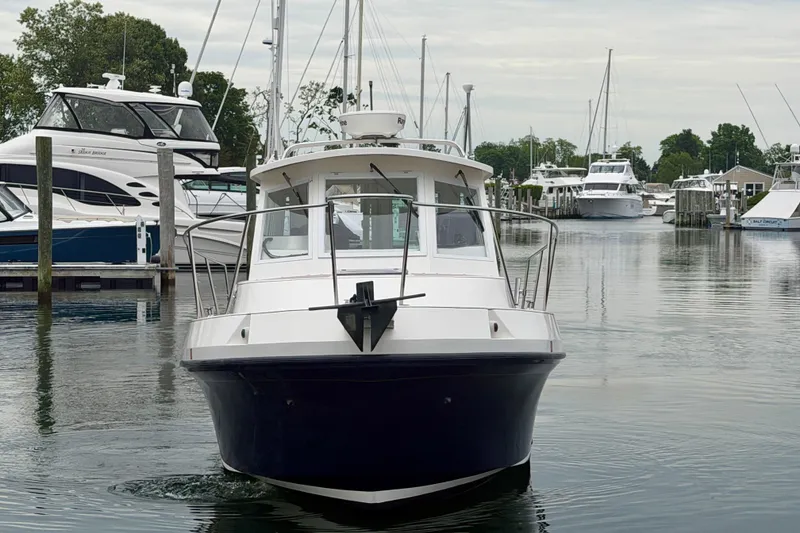 Slide: The Image of 2006 Albin 28 Tournament Express boat docked in a marina with other vessels. - 10