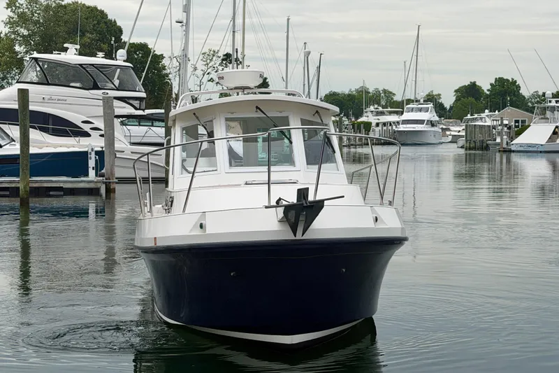 Slide: The Image of 2006 Albin 28 Tournament Express boat docked in a marina with other vessels. - 11