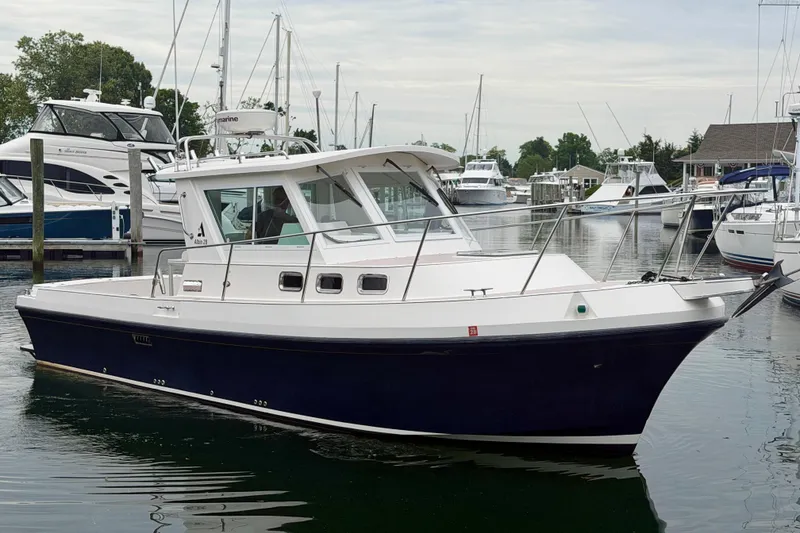 Slide: The Image of 2006 Albin 28 Tournament Express boat docked in a marina with other vessels. - 12