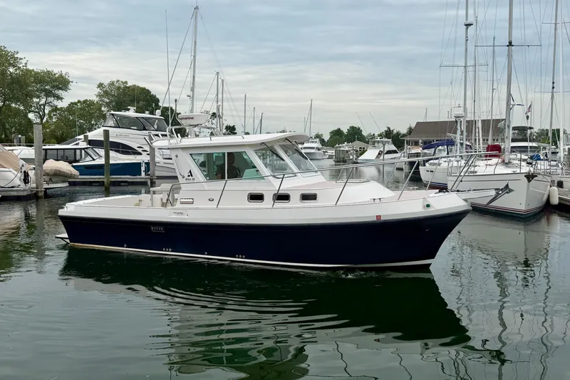 Slide: The Image of 2006 Albin 28 Tournament Express boat docked in a marina with other vessels. - 13