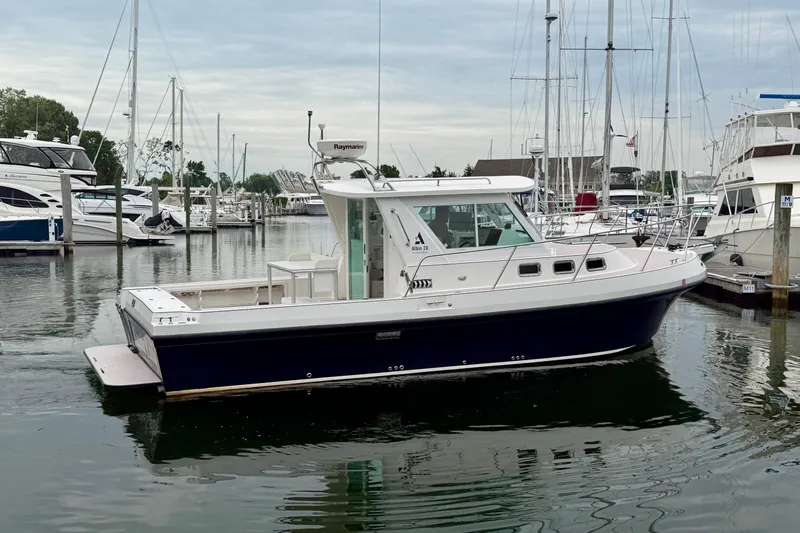 Slide: The Image of 2006 Albin 28 Tournament Express boat docked in a marina. - 15