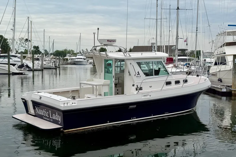 Slide: The Image of 2006 Albin 28 Tournament Express boat docked in marina, named "Nautic Lady." - 16