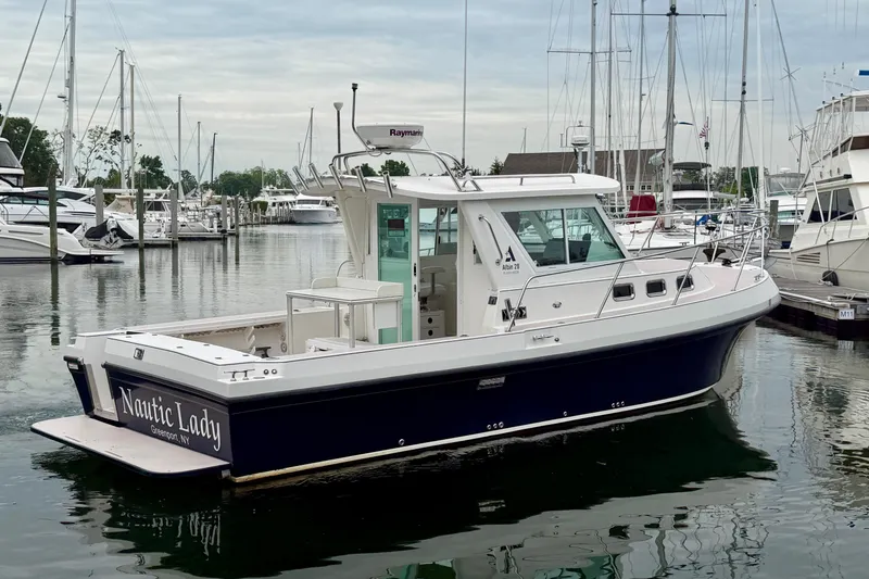 Slide: The Image of 2006 Albin 28 Tournament Express boat docked in a marina, featuring sleek design and spacious deck. - 17