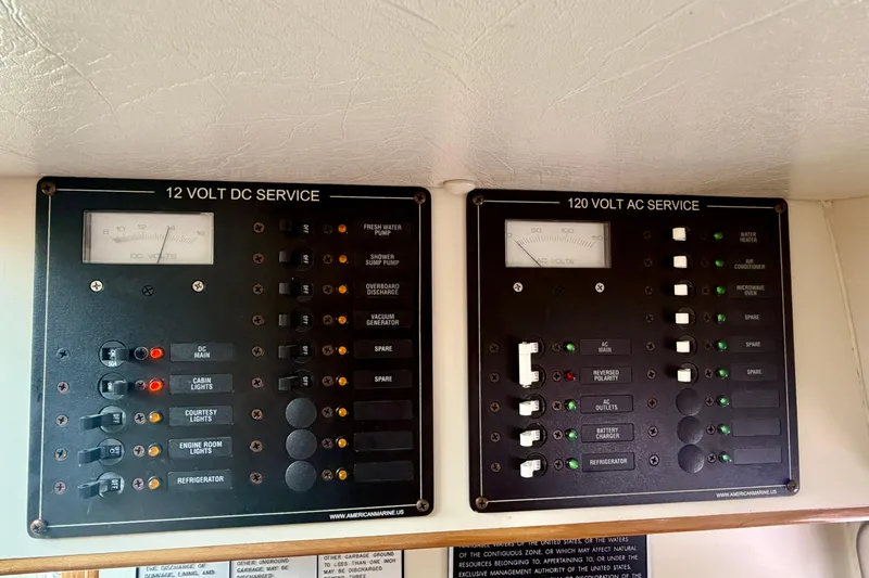 Slide: The Image of Electrical panels on a 2006 Albin 28 Tournament Express boat, featuring 12V DC and 120V AC services. - 21