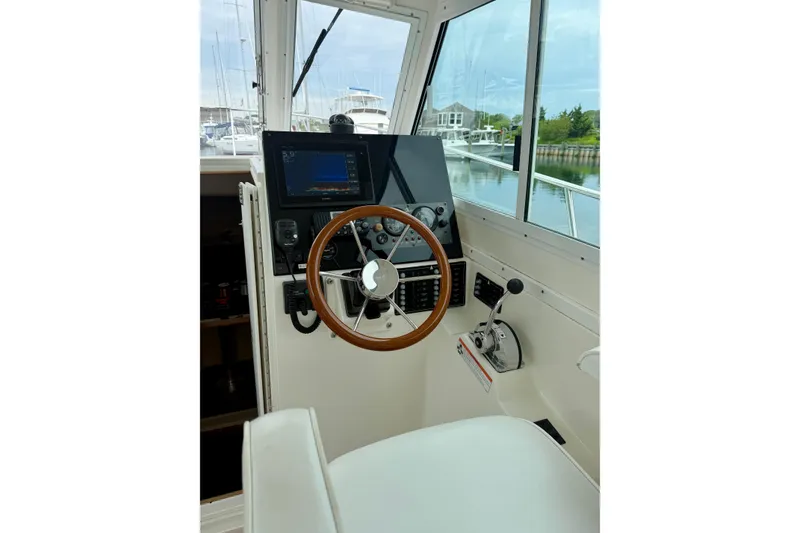 Slide: The Image of 2006 Albin 28 Tournament Express helm with wooden steering wheel and navigation equipment. - 26