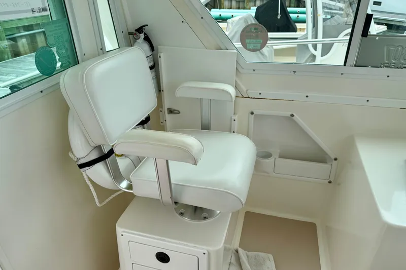Slide: The Image of Captain's chair in 2006 Albin 28 Tournament Express boat interior. - 29