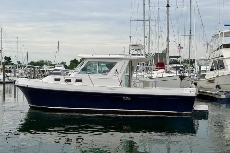 Slide: The Image of 2006 Albin 28 Tournament Express boat docked in a marina. - 3