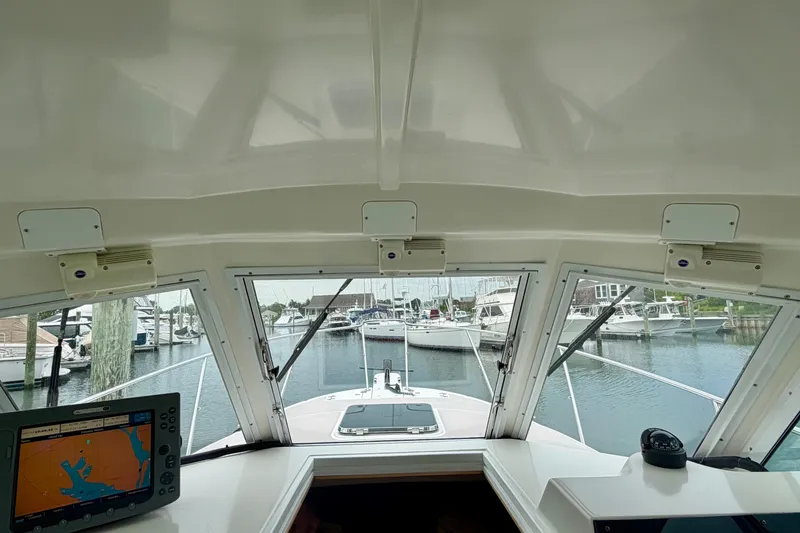 Slide: The Image of Interior view of 2006 Albin 28 Tournament Express boat cockpit with marina in background. - 30