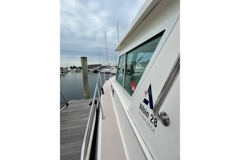 Slide: The Image of 2006 Albin 28 Tournament Express boat docked at marina under cloudy sky. - 32
