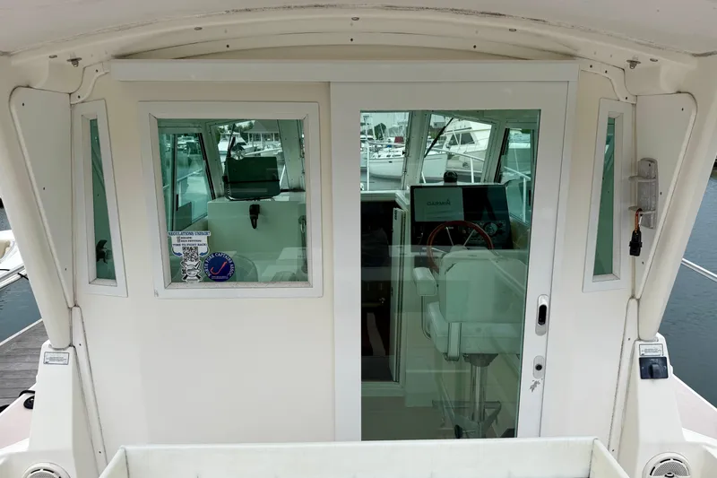 Slide: The Image of 2006 Albin 28 Tournament Express boat interior with helm and navigation equipment. - 36