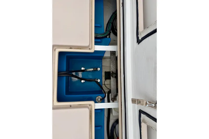 Slide: The Image of Engine compartment of a 2006 Albin 28 Tournament Express boat, showcasing blue interior components. - 37