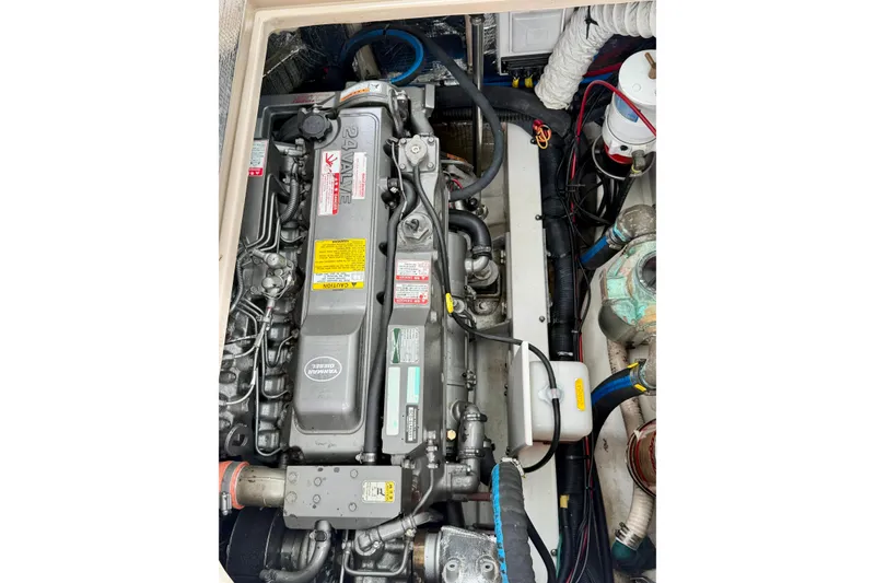 Slide: The Image of Engine compartment of a 2006 Albin 28 Tournament Express boat, showcasing detailed machinery. - 38