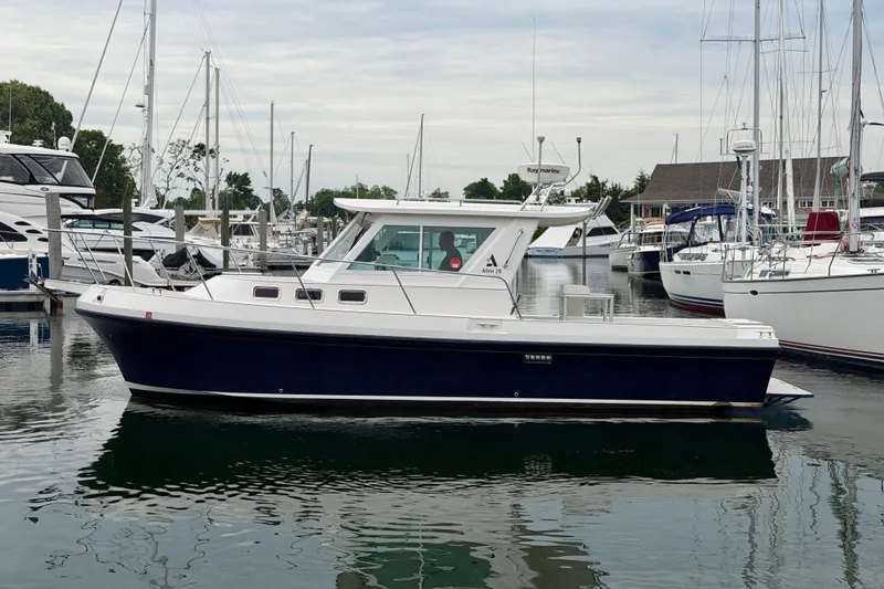 Slide: The Image of 2006 Albin 28 Tournament Express boat docked in a marina with sailboats. - 5