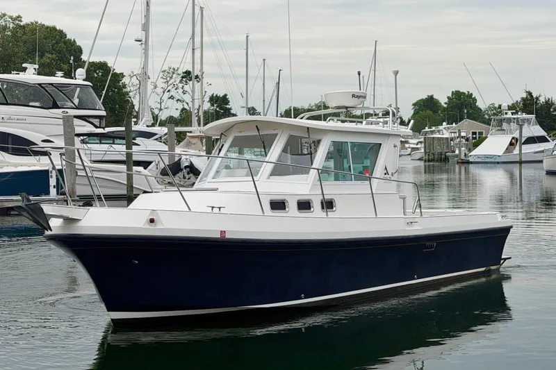 Slide: The Image of 2006 Albin 28 Tournament Express boat docked in a marina. - 8