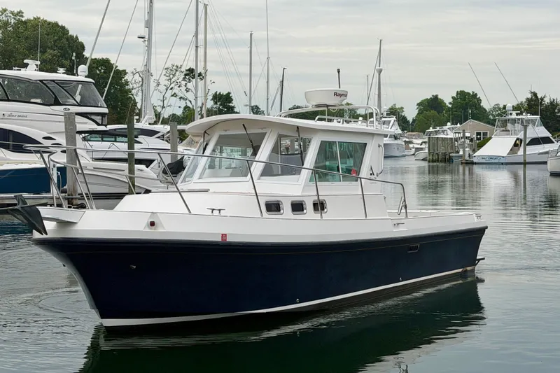 Slide: The Image of 2006 Albin 28 Tournament Express boat docked in a marina with other vessels. - 9