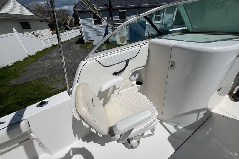 Slide: The Image of 2007 Seaswirl Striper 2301 Dual Console O/B boat interior with white seating and console. - 5
