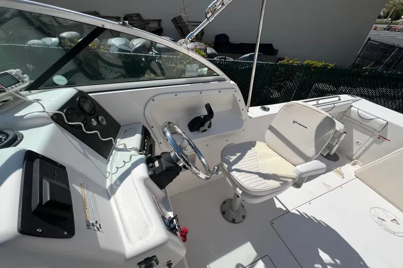 Slide: The Image of 2007 Seaswirl Striper 2301 Dual Console O/B boat interior with steering wheel and seating. - 6