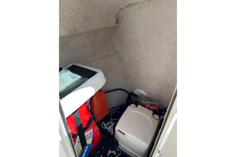 Slide: The Image of Storage compartment of 2007 Seaswirl Striper 2301 Dual Console O/B with life jackets and equipment. - 9