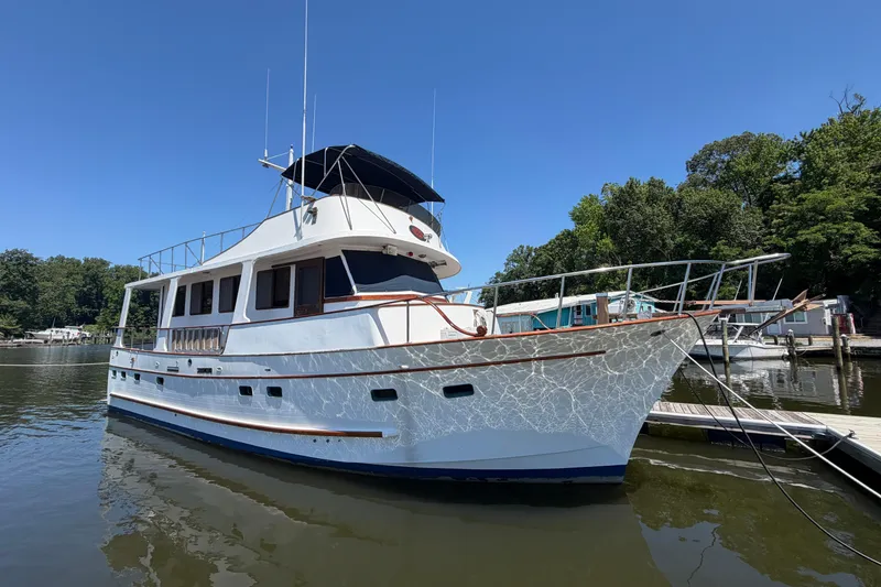 The Image of 1981 Marine Trader 50 yacht docked in a serene marina setting. - 0