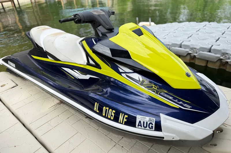 Slide: The Image of 2020 Yamaha WaveRunner VX Deluxe jet ski docked by the water. - 11