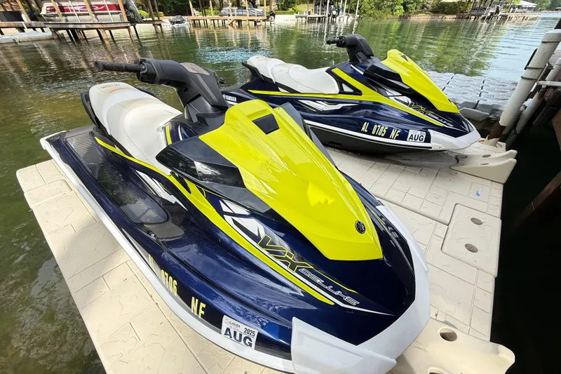 Slide: The Image of 2020 Yamaha WaveRunner VX Deluxe jet skis docked on a sunny day. - 4