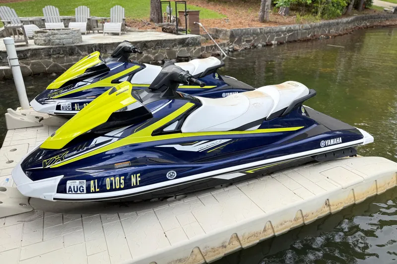 Slide: The Image of Two 2020 Yamaha WaveRunner VX Deluxe jet skis docked on a lakeside platform. - 5