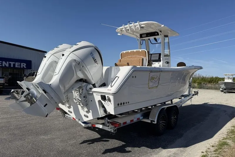 Slide: The Image of 2026 Sea Hunt Gamefish 27 boat with dual Yamaha engines on a trailer. - 13
