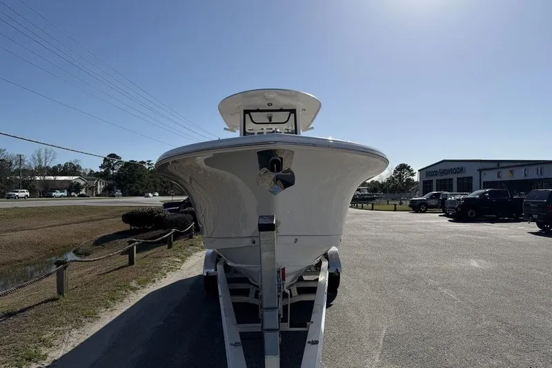 Slide: The Image of 2026 Sea Hunt Gamefish 27 boat on trailer, outdoor showroom setting. - 17