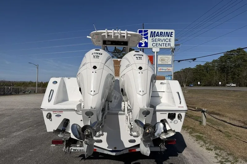 Slide: The Image of 2026 Sea Hunt Gamefish 27 with dual outboard motors at marine service center. - 8