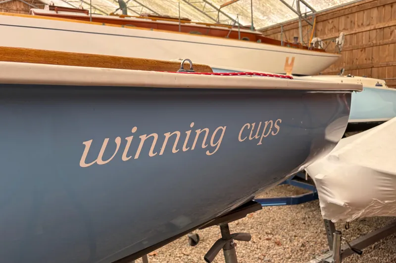 Slide: The Image of Blue Rhodes 19 sailboat from 1971 named "Winning Cups" in storage. - 7