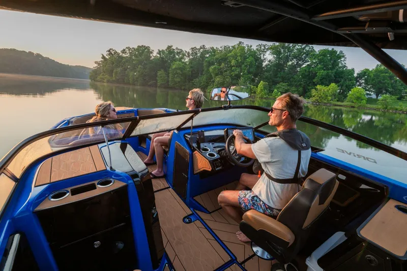 Slide: The Image of 2026 Yamaha Boats 255XD cruising on a serene lake with passengers enjoying the view. - 24