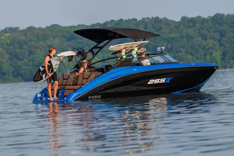 Slide: The Image of 2026 Yamaha Boats 255XD on a lake with people enjoying water activities. - 26