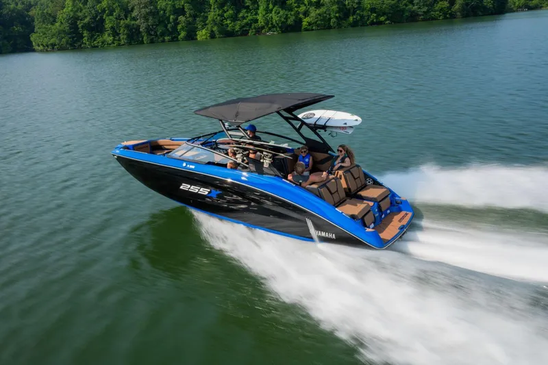 Slide: The Image of 2026 Yamaha Boats 255XD speeding on a lake with passengers enjoying the ride. - 28