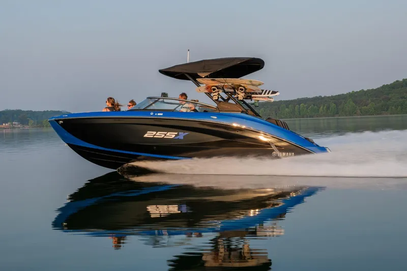 Slide: The Image of 2026 Yamaha Boats 255XD cruising on a calm lake with passengers onboard. - 4