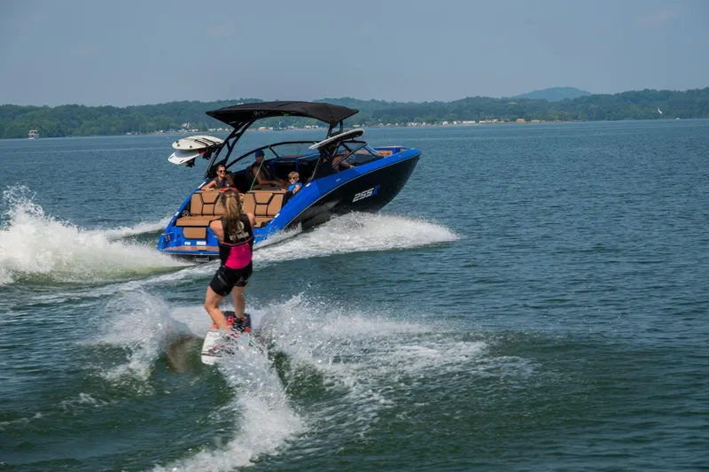 Slide: The Image of Wakeboarder enjoying a ride behind a 2026 Yamaha Boats 255XD on a sunny lake. - 7