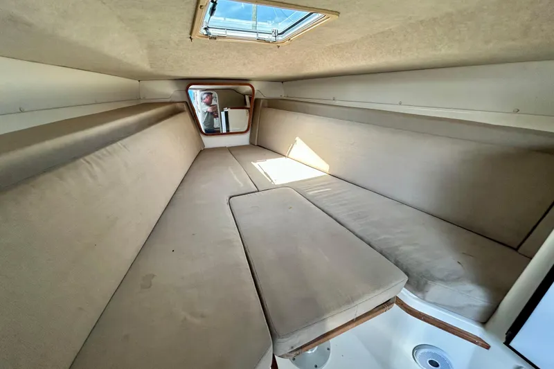 Slide: The Image of Interior cabin of 2001 Contender 35 Side Console boat with beige cushions. - 14