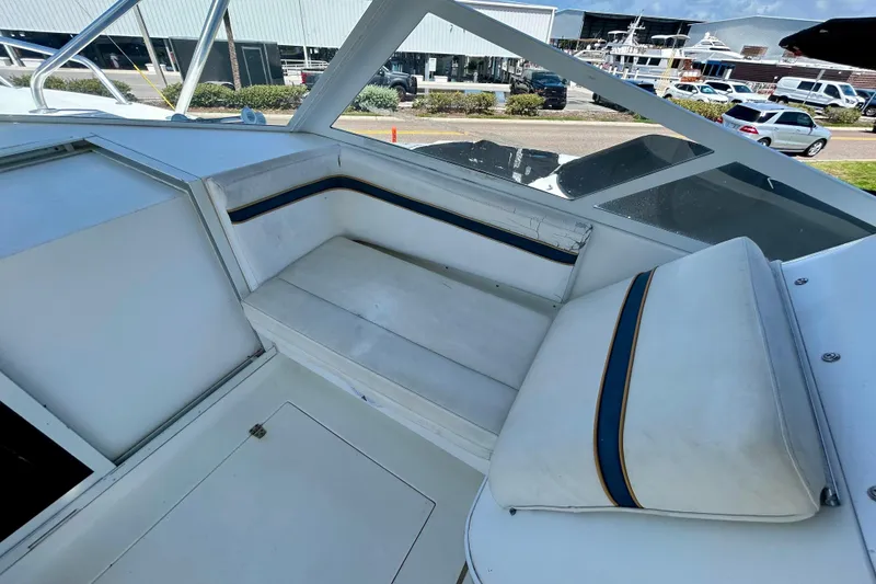 Slide: The Image of 2001 Contender 35 Side Console boat interior with white seating and blue accents. - 17