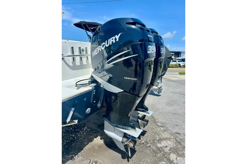 Slide: The Image of Triple Mercury Verado outboard engines on a 2001 Contender 35 Side Console boat. - 25