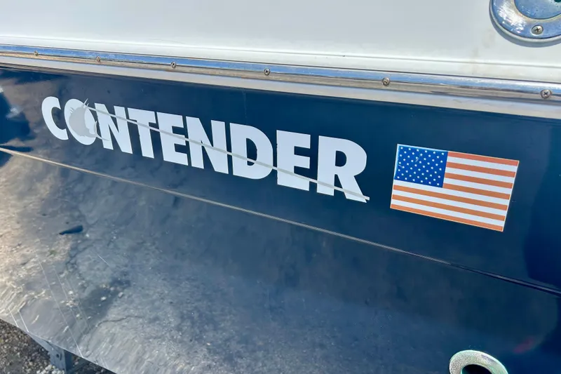 Slide: The Image of 2001 Contender 35 Side Console boat with American flag decal. - 26