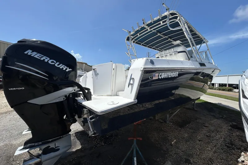 Slide: The Image of 2001 Contender 35 Side Console boat with Mercury Verado engine, docked outdoors. - 28