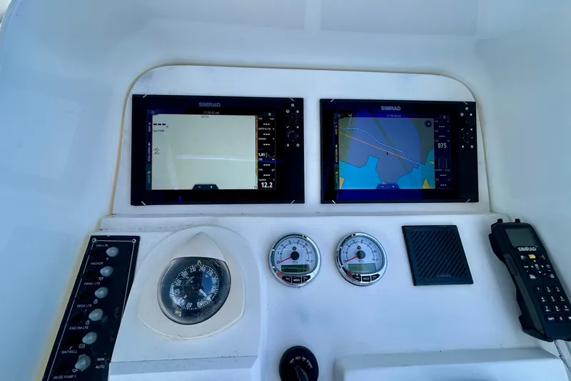 Slide: The Image of Control panel of 2001 Contender 35 Side Console with navigation screens and gauges. - 3