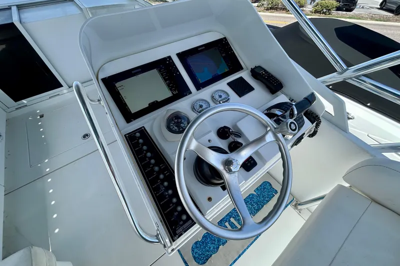 Slide: The Image of 2001 Contender 35 Side Console boat helm with steering wheel and navigation displays. - 4