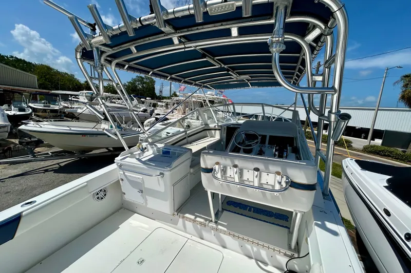 Slide: The Image of 2001 Contender 35 Side Console boat with canopy, docked among other vessels. - 7