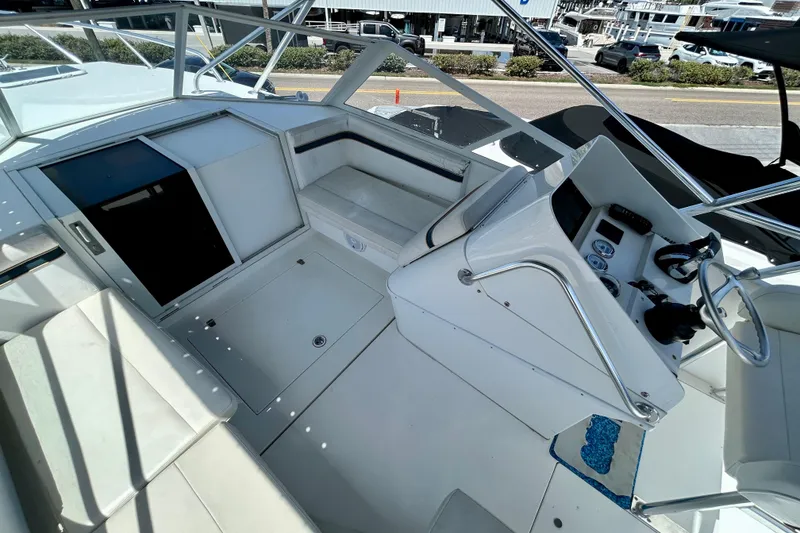 Slide: The Image of 2001 Contender 35 Side Console boat interior with helm and seating area. - 8
