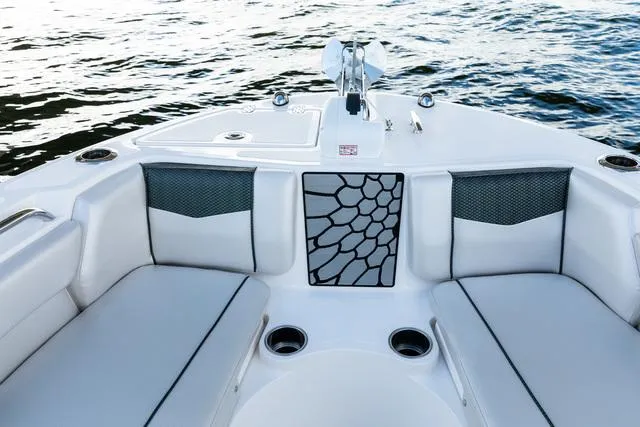 Slide: The Image of 2023 Wellcraft 222F boat interior with cushioned seating and modern design on the water. - 12