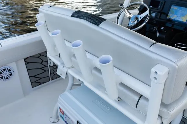 Slide: The Image of 2023 Wellcraft 222F boat interior with rod holders and steering console. - 8