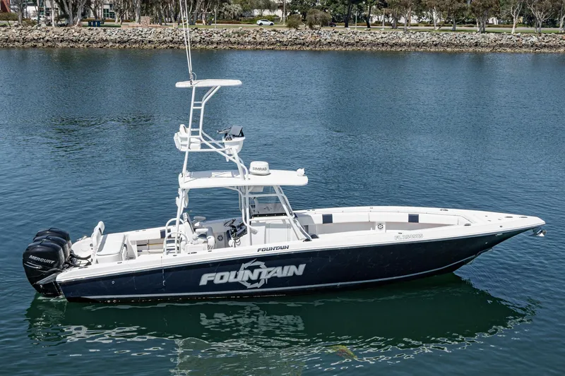 Slide: The Image of 2019 Fountain 38 CC boat on calm water, featuring dual Mercury engines. - 4